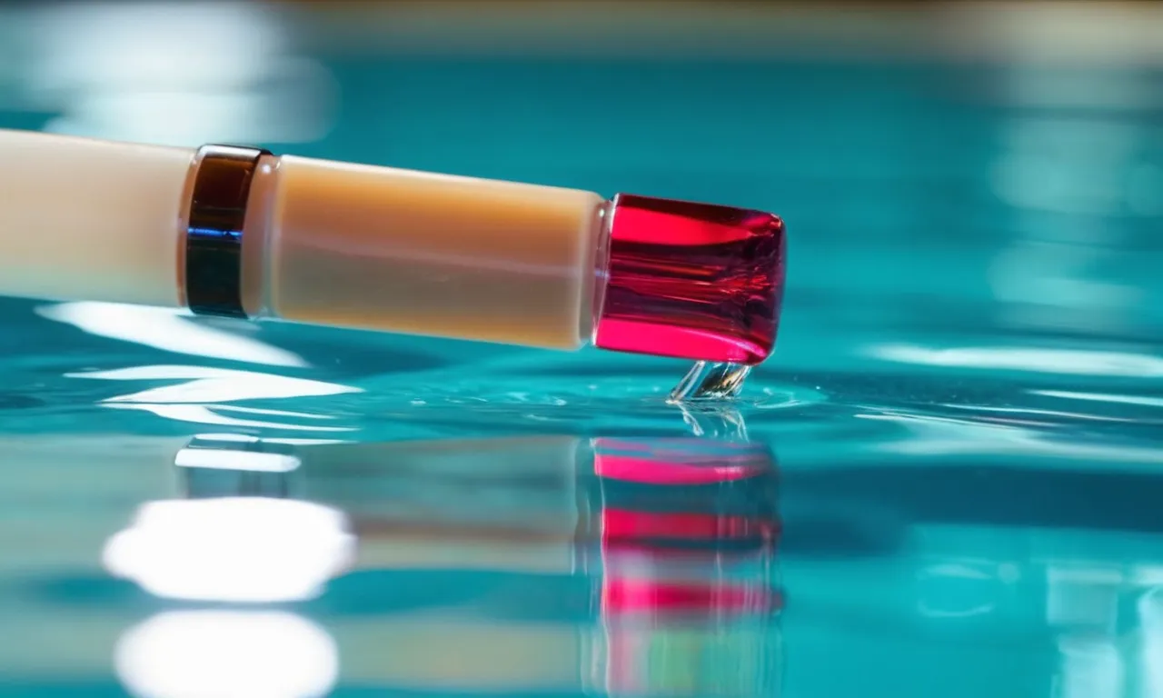 A close-up shot capturing the reflection of vibrant acrylic nails delicately skimming the surface of a crystal-clear swimming pool.