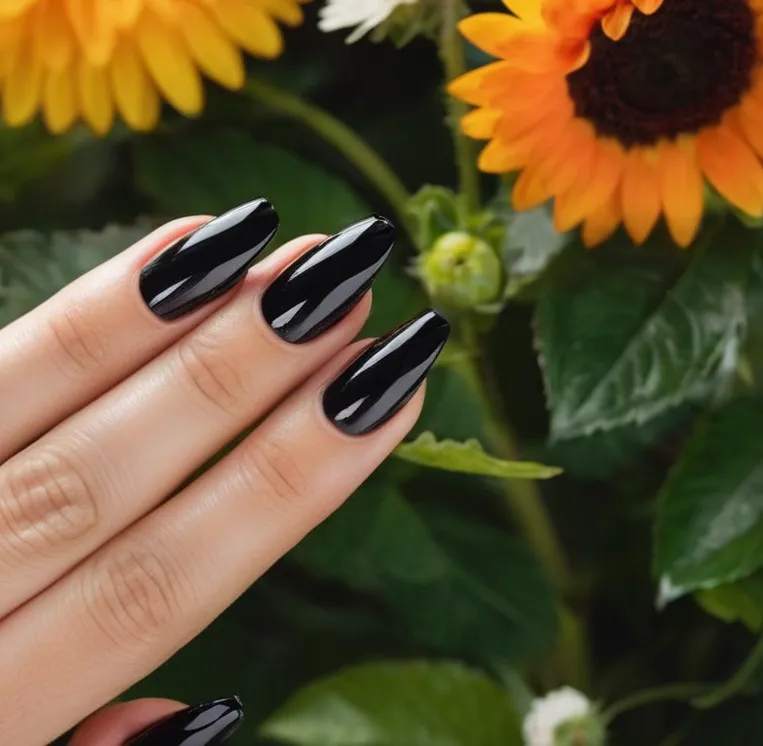 A close-up shot of a perfectly manicured hand with glossy black nails, contrasting against vibrant summer flowers in the background.